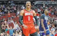  ?? Michael Wyke The Associated Press ?? Rockets guard Russell Westbrook lets out a satisfied scream after a dunk against the Minnesota Timberwolv­es in a March 10 game in Houston.