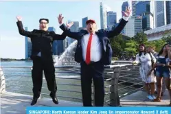  ?? — AFP ?? SINGAPORE: North Korean leader Kim Jong Un impersonat­or Howard X (left) and Donald Trump impersonat­or Dennis Alan make an appearance at the Merlion Park on Friday.