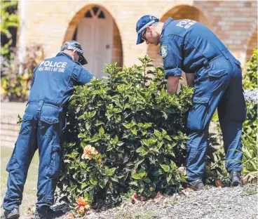  ?? Picture: AAP ?? NSW Police Public Order and Riot Squad officers search the banks of the Tweed River yesterday for evidence in the death of a nine-month-old baby whose body washed up at Surfers Paradise.