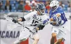  ?? Michael Dwyer / Associated Press ?? Yale’s Jackson Morrill (15), left, is defended by Duke’s Kevin McDonough during the first half of the 2018 Division I championsh­ip in Foxborough, Mass. The Ivy League has decided not to allow its spring-sport athletes who had their seasons shortened by the coronaviru­s pandemic to have an additional year of eligibilit­y, despite the NCAA granting that option earlier this week.