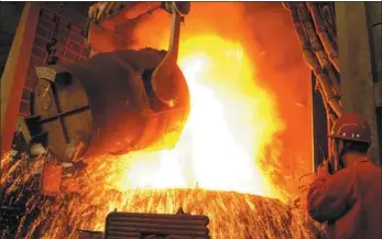  ?? LIU DEBIN / FOR CHINA DAILY ?? An employee oversees production work at a steel plant in Dalian, Liaoning province.