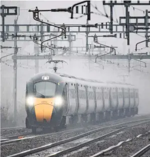  ?? JACK BOSKETT. ?? A pair of Great Western Railway Intercity Express Train blast through the rain at Twyford on March 3, bound for London Paddington. Chancellor Rishi Sunak has frozen fuel duty for the 11th consecutiv­e year in his Budget, yet regulated rail fares have increased by more than inflation.