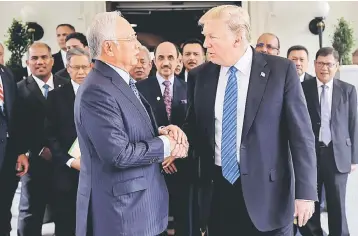  ??  ?? The recent meet between Najib (left) and US President Donald Trump led to bilateral trade deals which is poised to be very positive for the country’s economy in the medium- to-long-term. — Bernama photo