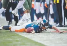  ?? John Leyba, The Denver Post ?? Broncos quarterbac­k Trevor Siemian dives for a first down in the first quarter Sunday against the Jets.