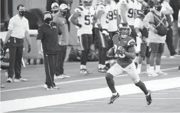  ?? KYUSUNG GONG AP ?? Rams running back Cam Akers, who gained 171 yards in the game, sprints down the sideline with the ball.