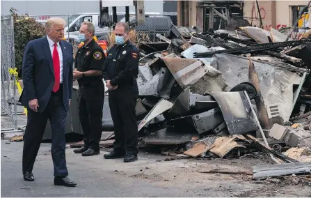  ?? THE ASSOCIATED PRESS ?? U.S. President Donald Trump on Tuesday tours an area of Kenosha, Wisconsin, that was damaged during demonstrat­ions after a police officer shot a Black man.