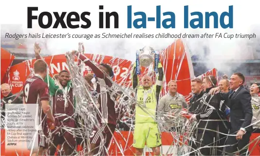  ??  ?? Leicester City’s goalkeeper Kasper Schmeichel (center) holds up the winner’s trophy as his teammates celebrate victory after the English FA Cup final against Chelsea at Wembley Stadium yesterday. – AFPPIX