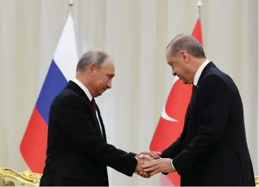  ?? (Reuters) ?? TURKISH PRESIDENT Recep Tayyip Erdogan (right) shakes hands with Russian counterpar­t Vladimir Putin, during their meeting in Tehran on September 7.