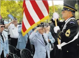  ?? Stephen Groves ?? The Associated Press Korean War veterans salute Friday as a member of an honor guard presents the American flag at the Korean War Memorial at Battery Park in New York.