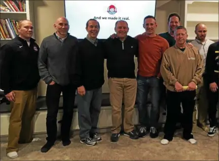  ?? MARK PODOLSKI - THE NEWS-HERALD ?? Former Lake Catholic wrestling coach Tim Armelli, third from left, and a host of others gather in Willoughby Hills on March 12 for the start of their annual trip to the NCAA Division I Wrestling Tournament.