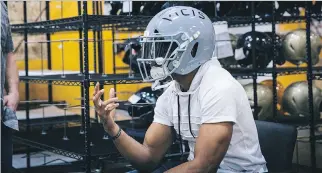  ?? RANDY RONQUILLO/THE ASSOCIATED PRESS ?? The Seahawks’ Doug Baldwin tries on the VICIS Zero1 helmet that NFL teams will test at minicamps. The Zero1 accounts for rotational impact, associated with concussion­s.