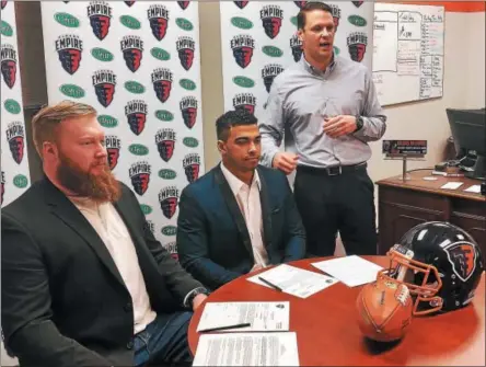  ?? PHOTO ALBANY EMPIRE/JORDAN LOMAESTRO ?? Albany Empire head coach Rob Keefe (standing) talks during Monday’s mornings free agent signing of Tamarac grad Wade Hansen (left) and Troy High grad Jordan canzeri (middle) by the Albany Empire AFL team.