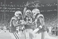  ?? MATT LUDTKE/ASSOCIATED PRESS ?? The Packers’ Davante Adams celebrates his touchdown catch with Marquez Valdes-Scantling and Allen Lazard, center, during Sunday’s game against the Bears in Green Bay, Wis.