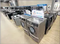  ?? AP PHOTO ?? In this 2017 file photo, the Kenmore Elite Smart Electric Dryer and Front Load Washer, center, appears on display at a Sears store, in West Jordan, Utah.