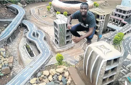  ?? / SUPPLIED ?? Mulalo Negondeni of Mukula village in Venda uses soil, sand, cement and recyclable waste materials to design his creations, like the FNB Stadium in the background.