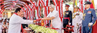  ??  ?? HISTORIC MOMENT: President Gotabaya Rajapaksa swears in his elder brother former President Mahinda Rajapaksa as the 13th Prime Minister of Lanka at the Audience Hall in the Temple of the Tooth