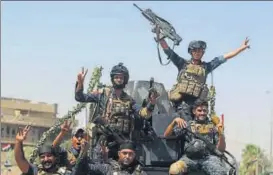  ?? AFP ?? Iraqi federal policemen raise the victory gesture while advancing through the Old City of Mosul.