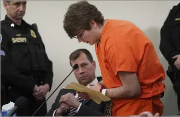  ?? DEREK GEE — THE BUFFALO NEWS VIA AP ?? Gunman Payton Gendron reads an apology to the court at sentencing for charges, including murder and domestic terrorism motivated by hate, before Erie County Court Judge Susan Eagan on Wednesday in Buffalo, N.Y.