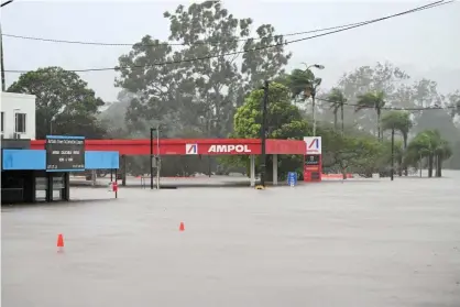  ?? Photograph: Dan Peled/Getty Images ?? A service station is inundated by floodwater on March 30, 2022 in Lismore, Australia as the city’s levee overtops. Evacuation orders have been issued for towns across the NSW Northern Rivers region, with flash flooding expected as heavy rainfall continues. It is the second major flood event for the region this month.