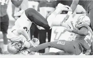  ?? JULIO AGUILAR/GETTY ?? USF cornerback Mazzi Wilkins, right, has been targeted by angry fans ever since delivering a helped severely injure UCF star quarterbac­k McKenzie Milton.