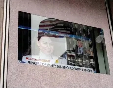  ?? ?? A screen displays the news of the Princess of Wales’s cancer diagnosis.