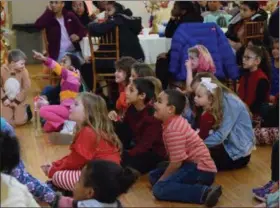 ??  ?? Kids smiled and laughed as they watched a magic show at Sunnybrook Ballroom. The show was part of the 35th annual holiday party for children.