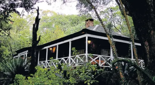  ??  ?? SWAZI DAYS: The garden cottage at Reilly’s Rock, above, and guide Dumisani Dlamini on the old Bailey bridge near Mantenga