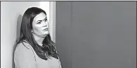  ?? AP/CAROLYN KASTER ?? Sarah Huckabee Sanders stands to the side Friday at a White House briefing during which she stuck to her view that it was a “fireable offense” for ESPN anchor Jemele Hill to call Trump a “white supremacis­t.”