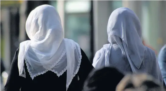  ??  ?? > The European Court of Justice has ruled that employers can ban employees from wearing religious symbols, including headscarve­s