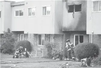  ??  ?? Firefighte­rs work on the blaze that caused an estimated $1-million damage to the Evergreen Terrace subsidized townhouse complex on Hillside Avenue.