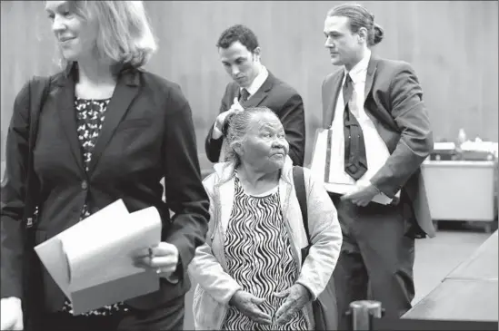  ?? Irfan Khan Los Angeles Times ?? ROSA CALDERON LOOKS back at the judge, as UCLA law professor Ingrid V. Eagly, left, and students Kevin Whitfield and Greg Bonett leave the courtroom.