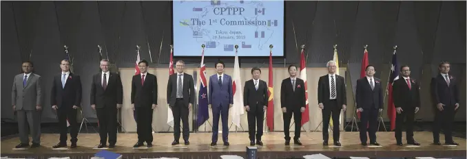  ?? Pool photo ?? Ministeria­l officials from the Trans-Pacific Partnershi­p countries line up in their first meeting in Tokyo in January 2019.