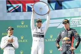  ?? Picture: REUTERS/ JULIAN SMITH ?? GOOD TEAM WIN: Mercedes’ second-placed Lewis Hamilton, winner Valtteri Bottas and third-placed Max Verstappen after the Formula One F1 Australian Grand Prix at the Albert Park Grand Prix Circuit in Melbourne, Australia on Sunday