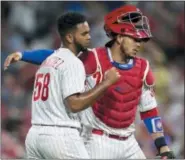  ?? LAURENCE KESTERSON — THE ASSOCIATED PRESS ?? Philadelph­ia Phillies closing pitcher Seranthony Dominguez (58) is embraced by catcher Jorge Alfaro after the Phillies defeated the Washington Nationals 3-2 in a baseball game, Saturday.