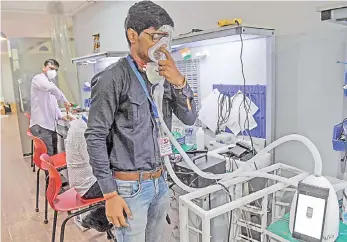  ?? — AFP photo ?? AgVa Healthcare employee Vaibhav Gupta demonstrat­es using a ventilator at the research and developmen­t (R&D) centre in Noida in Uttar Pradesh state.