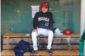  ?? STAFF PHOTO BY DOUG STRICKLAND ?? Lookouts manager Jake Mauer goes over paperwork in the dugout before the Lookouts’ season opener against the Mobile BayBears at AT&T Field on Thursday.