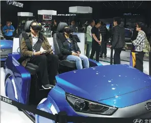  ?? PROVIDED TO CHINA DAILY ?? Visitors experience virtual reality technology in cars at this year’s Shanghai auto show.