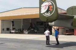  ??  ?? n Visitors attach a camera to a B-25 bomber on Friday at the Mid-America Flight Museum. The restored aircraft and the museum’s B-25 will fly Saturday to Dayton, Ohio, in honor of the anniversar­y of the Doolittle raid.