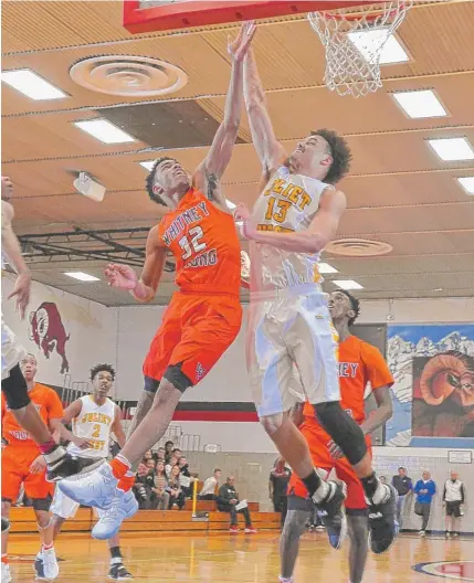  ?? | WORSOM ROBINSON/ FOR THE SUN- TIMES ?? Young sophomore Tyler Beard ( left) displayed an improved jumper at a camp last weekend in La Grange.