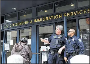  ?? AP/MARCIO JOSE SANCHEZ ?? Police officers stand outside the Immigratio­n and Customs Enforcemen­t office in San Francisco this week. Recent immigratio­n sweeps are frightenin­g workers and harming California’s farm industry, a farmers group says.