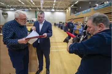  ?? Photo Domnick Walsh ?? Cameraman Reggie McCrohan films as Pa Daly and outgoing Kerry Sinn Féin TD Martin Ferris examines the tallies at the count centre in Killarney.
