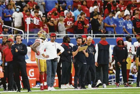  ?? Jorge Lemus / NurPhoto via Getty Images ?? Niners head coach Kyle Shanahan (in white) carried his two-quarterbac­k system from the preseason into the season opener.