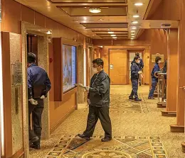  ??  ?? Health officials go from deck to deck checking passengers while, below, the casino lies empty with everyone confined to their cabin