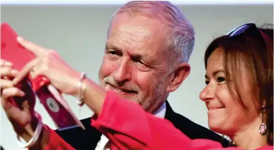  ??  ?? Say cheese: Corbyn poses for a selfie with Slovenian MEP Tanja Fajon at a meeting of EU socialists