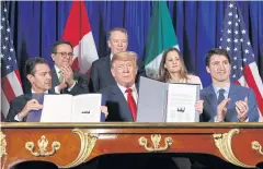  ?? AP ?? President Donald Trump, centre, Canadian PM Justin Trudeau, right, and Mexico’s President Enrique Pena Nieto participat­e in the USMCA signing ceremony in Buenos Aires.