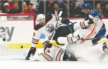  ?? RON CHENOY/ USA TODAY SPORTS ?? Oilers winger Josh Archibald collides with goaltender Mikko Koskinen as the puck crosses the goal line during second period action in Game 1 of the Western Conference Final against the Avalanche on Tuesday night. Game 2 goes Thursday.