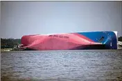  ?? STEPHEN B. MORTON / AP FILE ?? In this Sept. 9, 2019, file photo, a Moran tugboat nears the stern of the capsizing vessel Golden Ray near St. Simons Sound off the coast of Georgia.