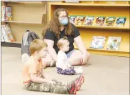  ?? LYNN KUTTER ENTERPRISE-LEADER ?? Top photo: Sherri Cruz and her daughter Kimber, 4, of Farmington, participat­e in Storytime at Prairie Grove Public Library. Bottom photo: Faith Walton of Farmington and her children Samuel, 3, and Stella, 9 months, were among several families who attended Storytime at Prairie Grove Public Library. Children’s Librarian Amanda Thulin and library assistant Molly Hutchins read books about going to kindergart­en.