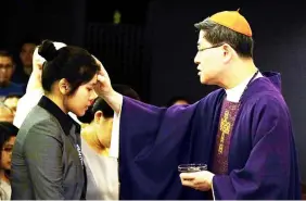  ?? Roy Lagarde/CBCP File Photo ?? ASH WEDNESDAY. Cardinal Luis Antonio Tagle places ashes on the head of a woman during the Ash Wednesday Mass at the Manila Archdioces­e Chapel in Intramuros, Manila.—