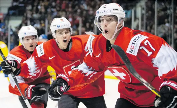  ?? — THE CANADIAN PRESS ?? Switzerlan­d’s Luca Wyss, right, celebrates his goal against Sweden with teammates Sandro Schmid and Matthew Verboon during world juniors quarter-final action in Victoria on Wednesday. Switzerlan­d won 2-0.